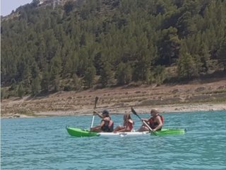Panoramic view of the Guadalest reservoir from a kayak, with the sky reflected in the water