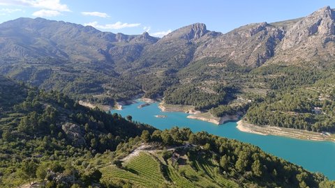 Person practising yoga at sunrise by the Guadalest reservoir